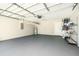 Spacious garage with epoxy floor, shelving, and water heater, offering ample storage and functionality at 11226 Thicket Ct, Tampa, FL 33624