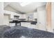 Well-equipped kitchen with white cabinets, dark countertops, and tile flooring at 11226 Thicket Ct, Tampa, FL 33624