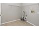 Laundry room featuring wire rack shelving, tile flooring, and a utility connection at 11226 Thicket Ct, Tampa, FL 33624