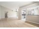 Open-concept living room with tile flooring and view of the kitchen and breakfast bar at 11226 Thicket Ct, Tampa, FL 33624