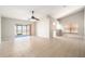 Bright living room featuring neutral walls, tiled flooring, and a sliding glass door at 11226 Thicket Ct, Tampa, FL 33624