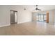 Spacious living room with tile flooring, ceiling fan, and sliding door access to the backyard at 11226 Thicket Ct, Tampa, FL 33624