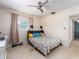 Bedroom featuring a ceiling fan, and large window, with a double bed at 11397 122Nd Ave, Largo, FL 33778