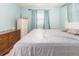 This bedroom has light blue walls, a large window, and dressers for storage at 11397 122Nd Ave, Largo, FL 33778