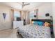This room features a bed, a ceiling fan, and two windows for natural light at 11397 122Nd Ave, Largo, FL 33778