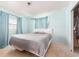 Bright bedroom with light blue walls and window overlooking the yard at 11397 122Nd Ave, Largo, FL 33778