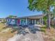 Charming one-story home with covered parking, red door, and freshly painted exterior at 11397 122Nd Ave, Largo, FL 33778