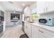 Bright kitchen featuring new appliances, cabinets, and countertops with a blue microwave at 11397 122Nd Ave, Largo, FL 33778