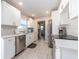 A spacious kitchen, featuring all white cabinetry, stainless steel appliances, and new wood-look flooring at 11397 122Nd Ave, Largo, FL 33778