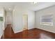 Well-lit bedroom featuring hardwood floors and a window providing plenty of natural light at 12817 Darby Ridge Dr, Tampa, FL 33624
