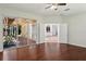 Bedroom with hardwood floors features an open doorway to the kitchen and glass doors to the patio at 12817 Darby Ridge Dr, Tampa, FL 33624