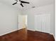Bedroom features hardwood floors and a double door closet for ample storage space at 12817 Darby Ridge Dr, Tampa, FL 33624