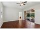 Comfortable bedroom showcasing hardwood floors and access to the backyard patio at 12817 Darby Ridge Dr, Tampa, FL 33624