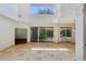 Living room featuring high ceilings, travertine floors, and patio access at 12817 Darby Ridge Dr, Tampa, FL 33624