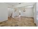 Bright living room showcasing the travertine flooring and staircase at 12817 Darby Ridge Dr, Tampa, FL 33624