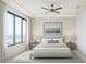 Serene bedroom with large window offering ocean view, complemented by neutral tones and minimalist decor at 1311 Sea Gull S Dr, St Petersburg, FL 33707