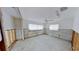 Picture showcasing a bedroom with windows and a ceiling fan, needing a complete remodel with new flooring at 1311 Sea Gull S Dr, St Petersburg, FL 33707