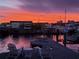 Waterfront view from the dock with a fiery pink sunset over the water at 1311 Sea Gull S Dr, St Petersburg, FL 33707