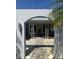 Charming home entrance with stone pathway, lush landscaping, and a welcoming, arched doorway at 1311 Sea Gull S Dr, St Petersburg, FL 33707