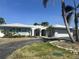 Exterior view of home highlighting the arched entryway and tile roof at 1311 Sea Gull S Dr, St Petersburg, FL 33707