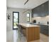Stunning modern kitchen with minimalist design, a spacious island with seating and ocean view at 1311 Sea Gull S Dr, St Petersburg, FL 33707