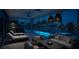 Cozy living area featuring comfortable seating, ambient lighting, and stunning waterfront views and pool access at 1311 Sea Gull S Dr, St Petersburg, FL 33707