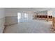 Partially renovated living room with view to exterior patio via sliding glass doors to canal at 1311 Sea Gull S Dr, St Petersburg, FL 33707