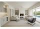Bright, modern living room with a fireplace, sleek furniture, built-in shelving, and access to a pool at 1311 Sea Gull S Dr, St Petersburg, FL 33707