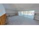 Picture showcasing the living room with pool view, needing complete remodel with new flooring and drywall at 1311 Sea Gull S Dr, St Petersburg, FL 33707