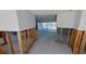 Partially renovated living room with view to exterior patio via sliding glass doors to pool at 1311 Sea Gull S Dr, St Petersburg, FL 33707