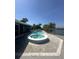 Waterfront view featuring a pool, hot tub, and dock on a beautiful sunny day at 1311 Sea Gull S Dr, St Petersburg, FL 33707