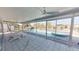 Enclosed patio with water views, featuring outdoor seating and access to the pool and waterfront at 1311 Sea Gull S Dr, St Petersburg, FL 33707