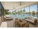 Bright sunroom with waterfront views featuring a pool, jacuzzi, and comfortable seating at 1311 Sea Gull S Dr, St Petersburg, FL 33707