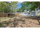 Fenced backyard with rear view of home, trees, and lawn at 1427 Gerard Ln, Holiday, FL 34690
