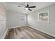 Bedroom features wood-look vinyl flooring and windows at 1427 Gerard Ln, Holiday, FL 34690