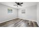 Bedroom features wood-look vinyl flooring and two windows at 1427 Gerard Ln, Holiday, FL 34690