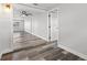 View of entry hall to rooms with wood-look vinyl flooring at 1427 Gerard Ln, Holiday, FL 34690