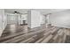 Spacious living room with modern flooring seamlessly connecting to the kitchen area at 1427 Gerard Ln, Holiday, FL 34690