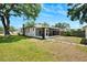 A lovely screened in porch is attached to this single-story home with an ample green lawn at 1601 54Th S St, Gulfport, FL 33707