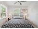 Cozy bedroom with a comfortable bed, bedside tables with lamps, and natural light from two windows at 1601 54Th S St, Gulfport, FL 33707