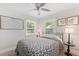 Cozy bedroom with a comfortable bed, ceiling fan, and bright natural light from two windows at 1601 54Th S St, Gulfport, FL 33707