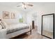 Bright bedroom featuring neutral decor, a cozy bed, and a glimpse into a walk-in closet at 1601 54Th S St, Gulfport, FL 33707