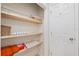 A closet featuring wooden shelves, storage baskets, and towels, providing practical organization at 1601 54Th S St, Gulfport, FL 33707