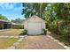 Detached garage with fresh white siding, accent plants, and a charming walkway at 1601 54Th S St, Gulfport, FL 33707