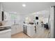 Modern kitchen with white cabinets, stainless steel appliances, flowing into a spacious living area at 1601 54Th S St, Gulfport, FL 33707