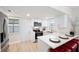 Bright kitchen featuring white cabinets, stainless steel appliances, and a breakfast bar with red seating at 1601 54Th S St, Gulfport, FL 33707