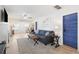 Bright living room with a comfortable blue sofa, stylish decor, and a charming blue accent door at 1601 54Th S St, Gulfport, FL 33707