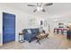 Open-concept living space with a blue sofa, view of the kitchen, and access to a vibrant blue door at 1601 54Th S St, Gulfport, FL 33707