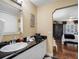 Bathroom featuring a vanity with a black countertop and view into main bedroom at 1702 Cordova Green, Seminole, FL 33777