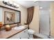 Bathroom with a shower, vanity, framed mirror, and decorative accents at 1702 Cordova Green, Seminole, FL 33777